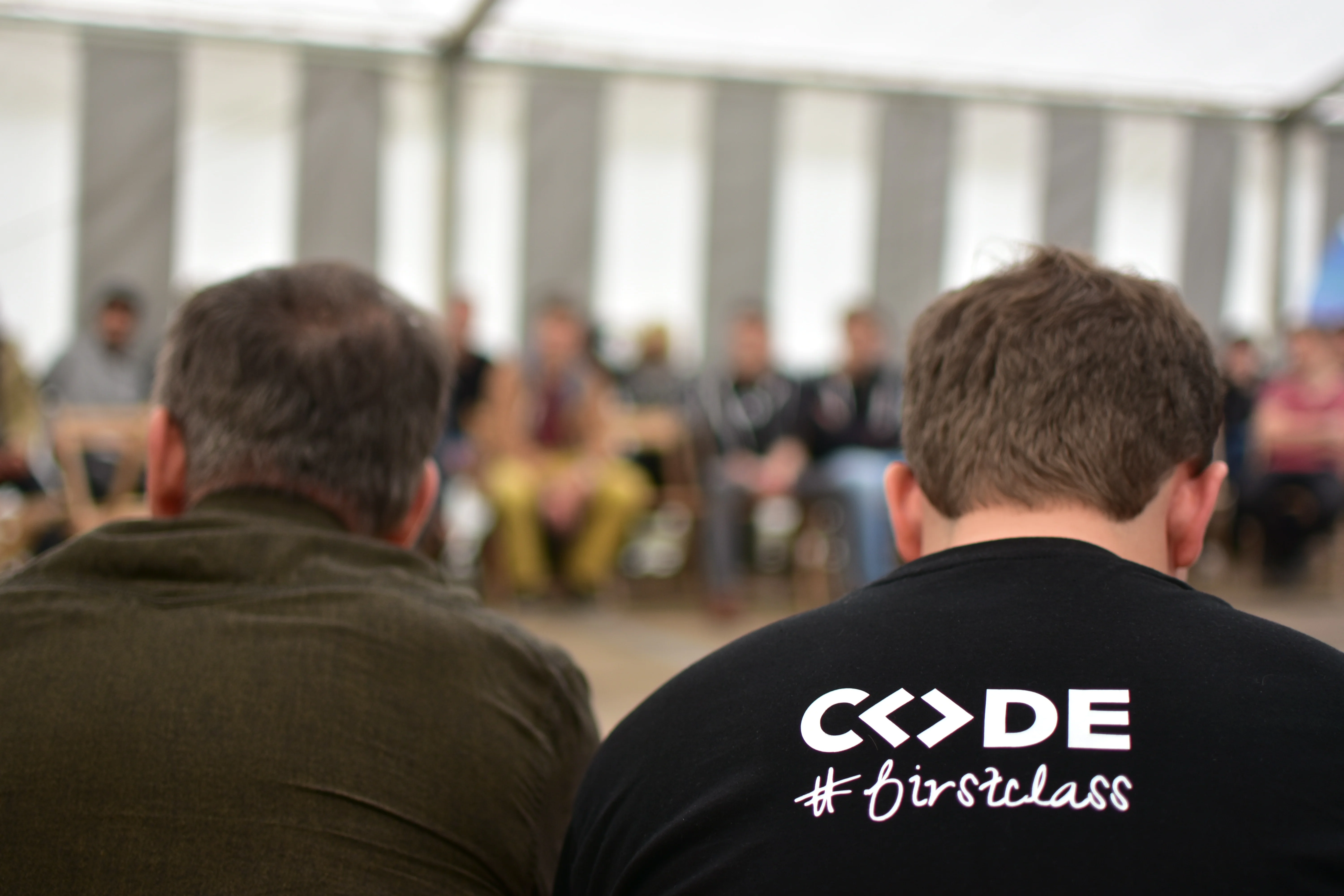 a large group of people are posing for a picture with a dog .