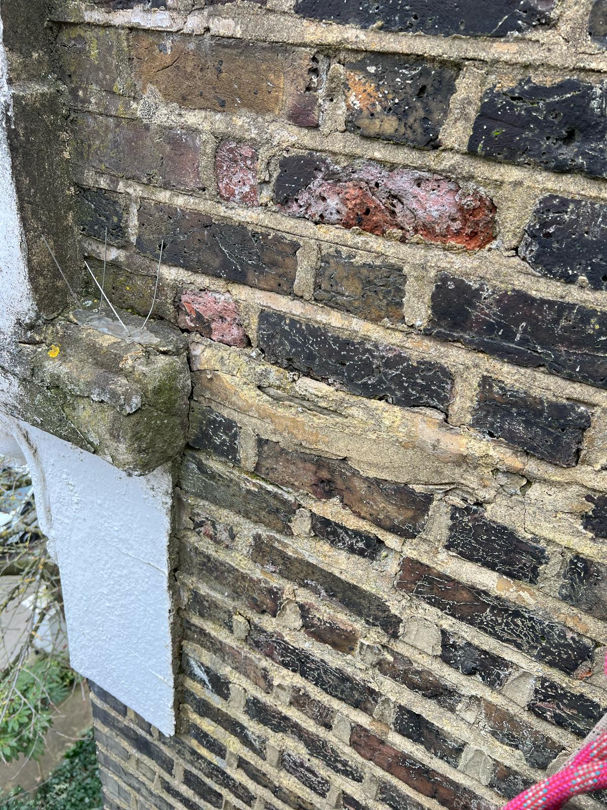 Photo 1 – Before: Failed brickwork pointing causing water ingress and internal damp damage.