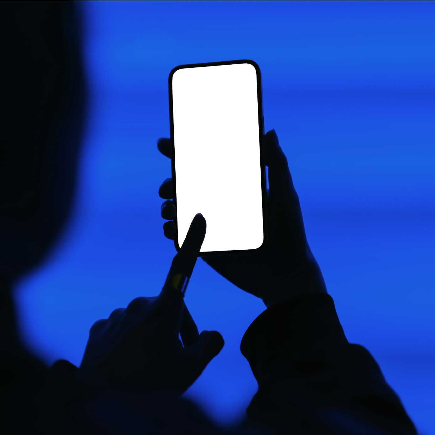 Silhouette of hand holding smartphone displaying Drivvn-powered automotive eCommerce storefront interface against blue background