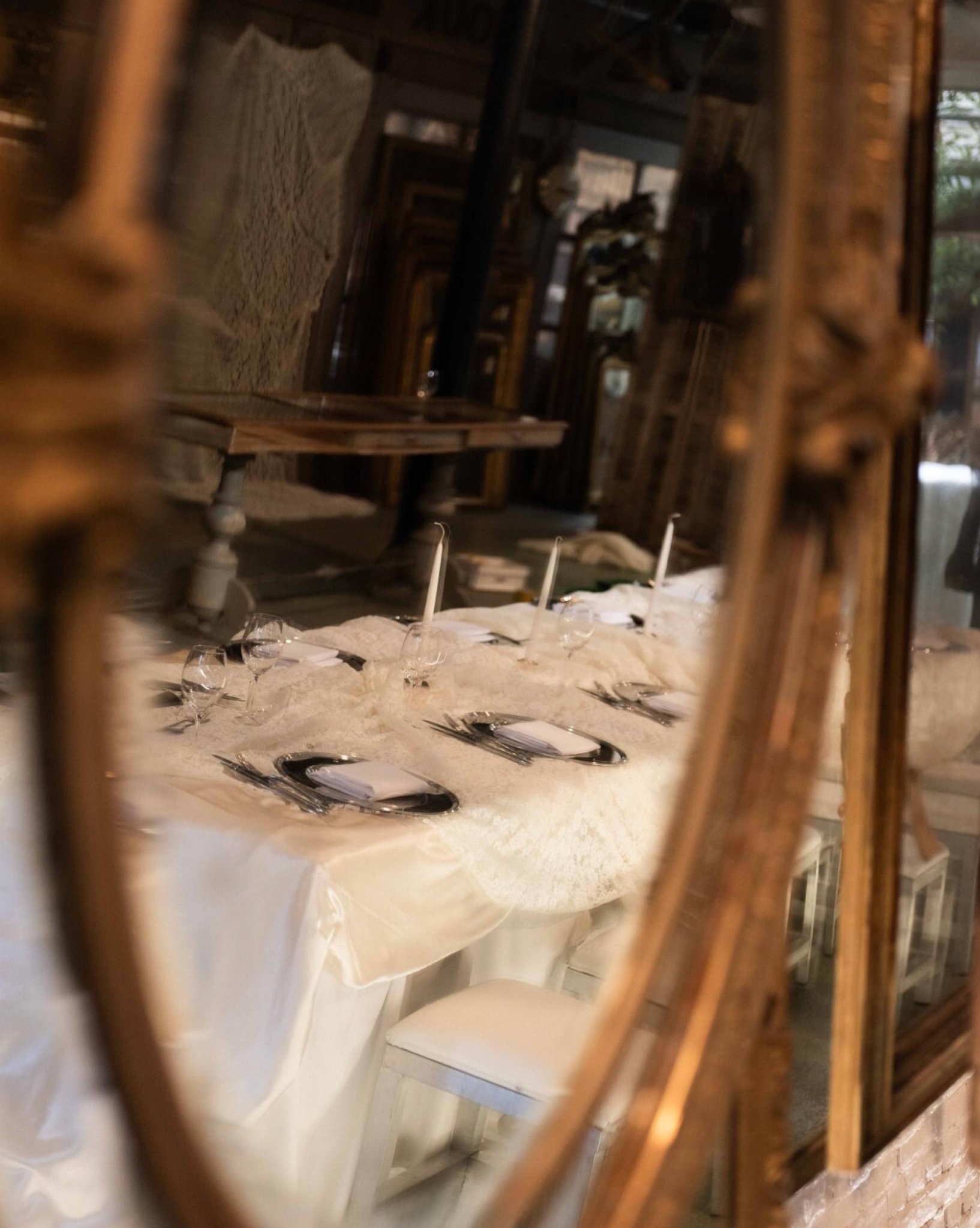 Laagam dinner table on white lace with mirror chargers