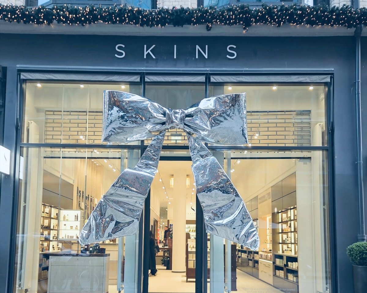 A large silver bow tied across the glass front of the Skins store