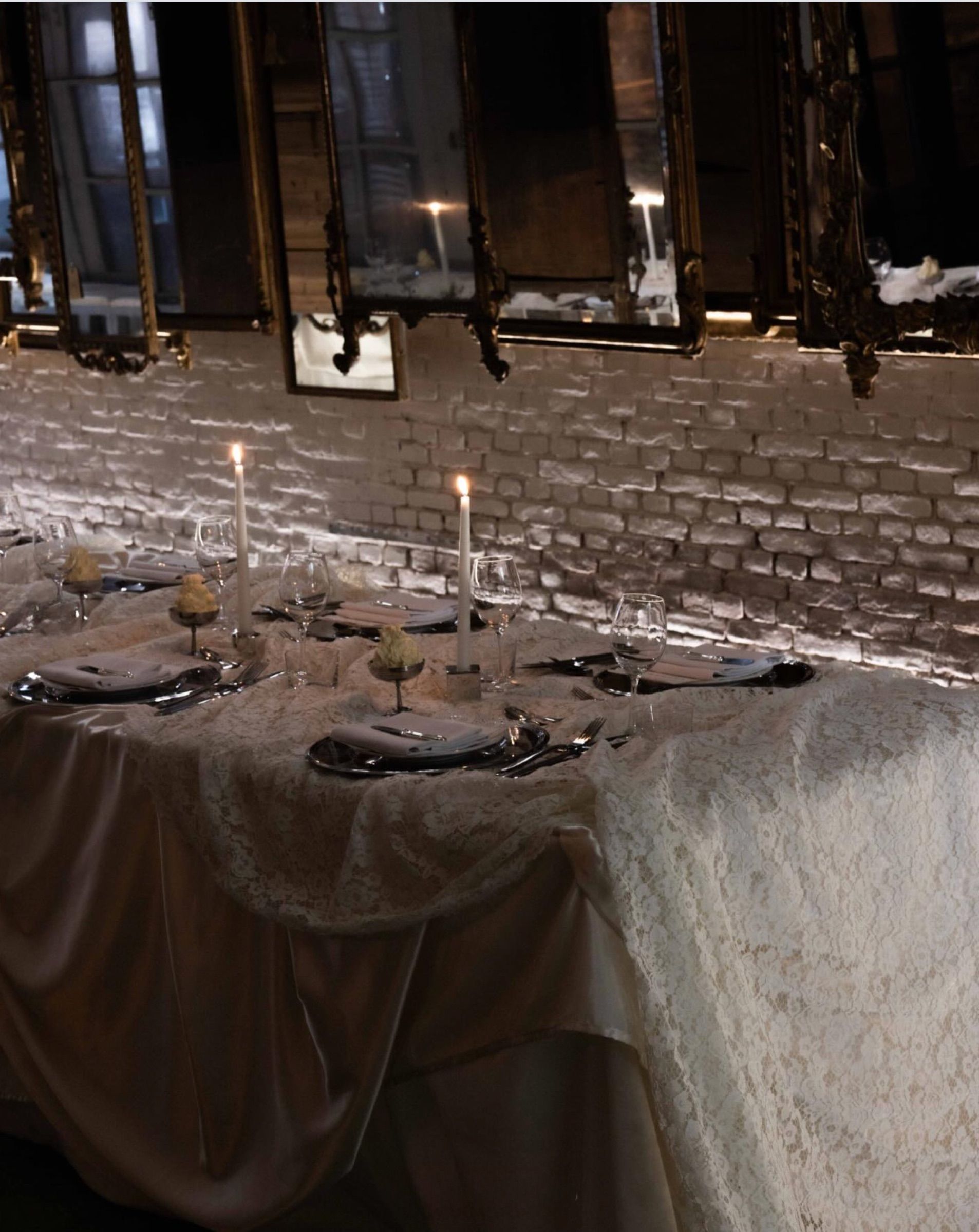 Laagam dinner table on white lace with mirror chargers