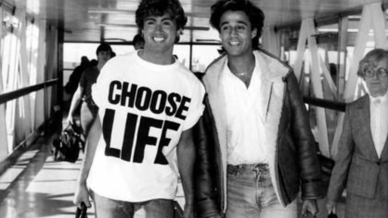 A black-and-white photo of George Michael wearing a 