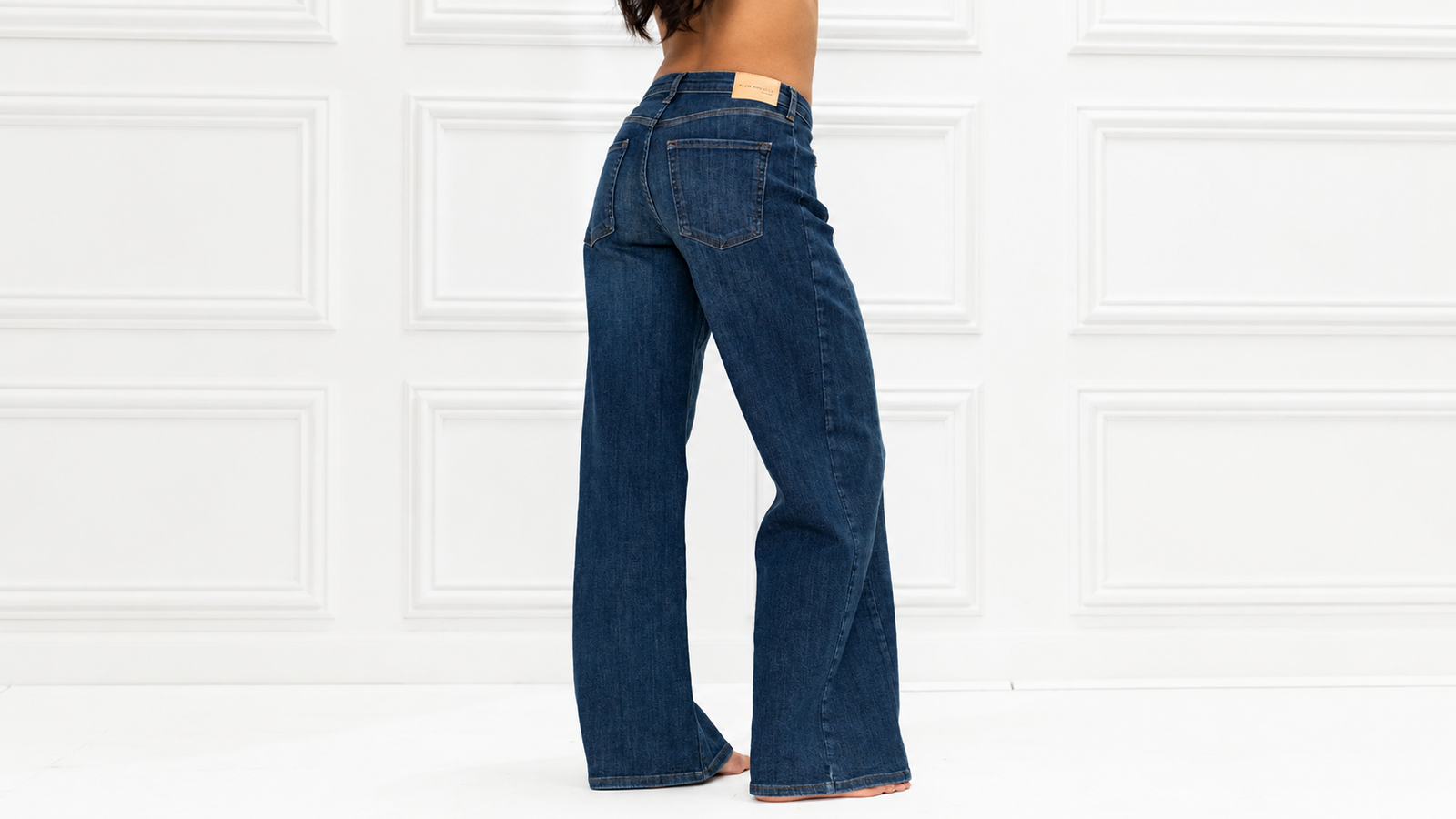 Dark blue wide-leg jeans, shown from the side-back.