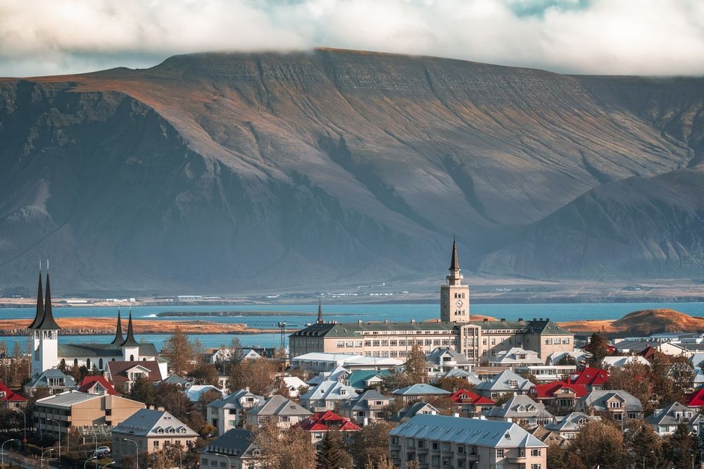 A cruise ship at an Icelandic port with mountains behind