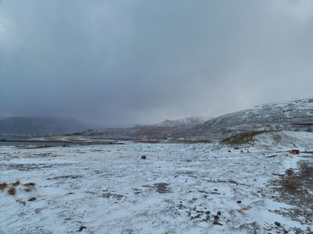 Snow-covered pastures and hills in the Icelandic countryside.