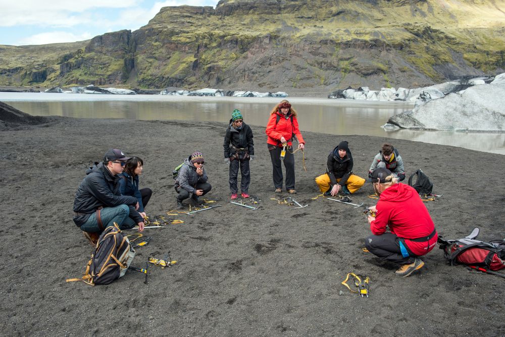 Tourists making a glacier hiking with a private tour guide in the Solheimajokull, Iceland