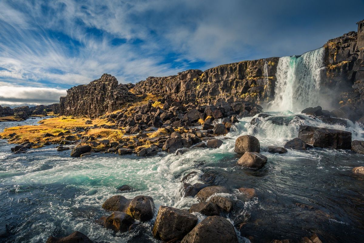 Oxararfoss waterfall dropping over the basalt cliff at Thingvellir