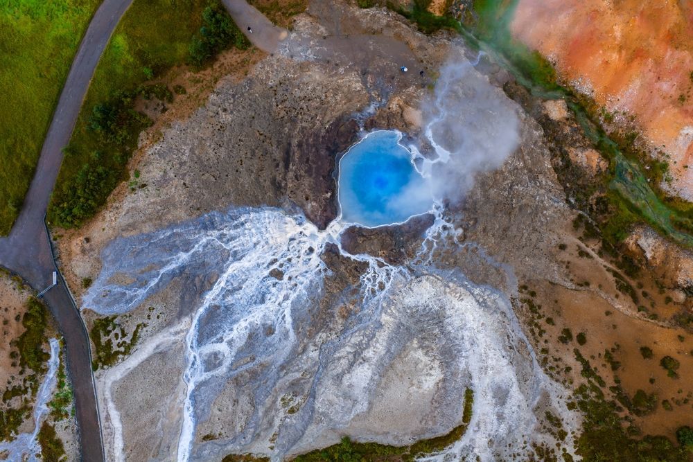 Aerial view of a turquoise hot spring in the Geysir geothermal field