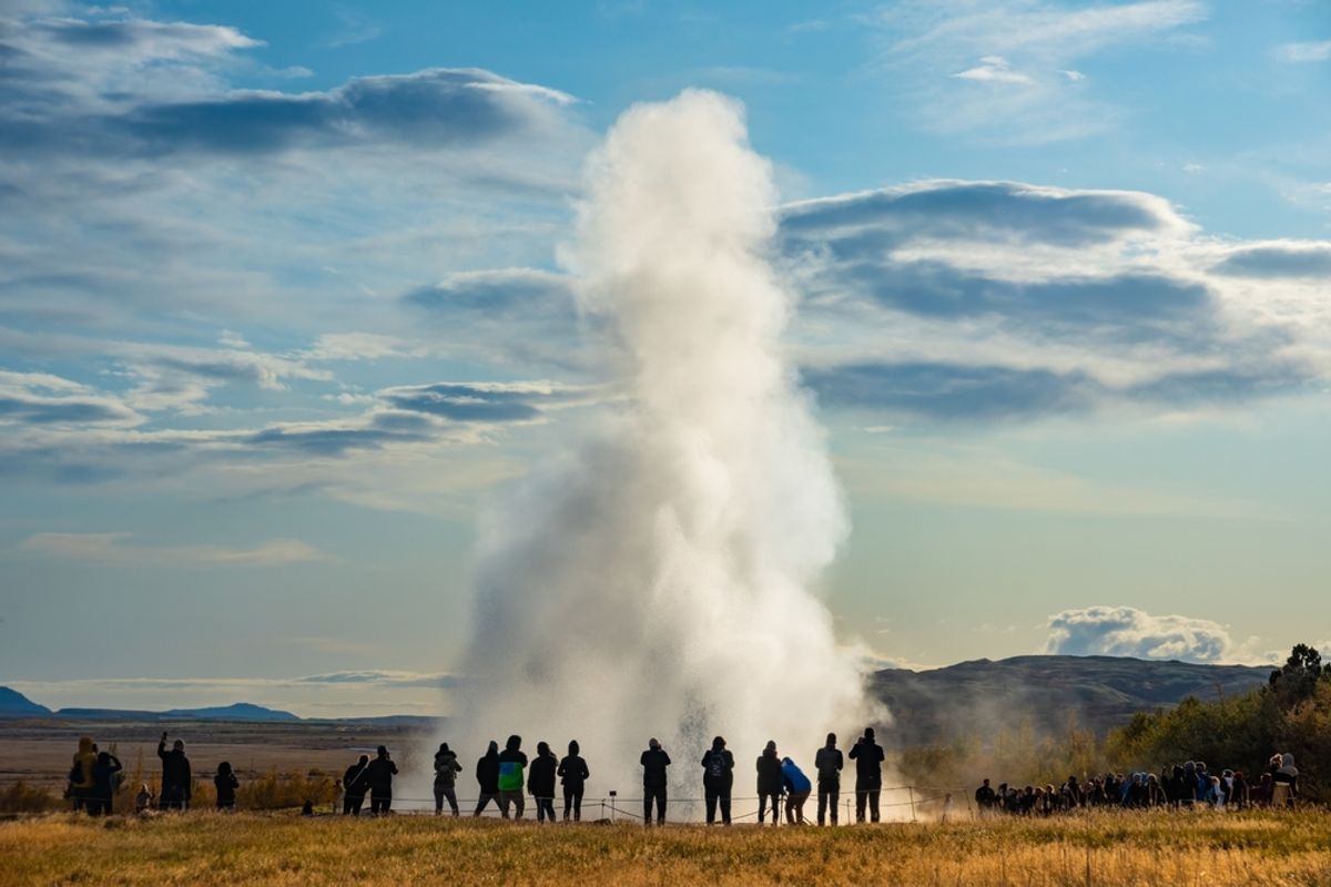 Crowd watching the dramatic Strokkur Geyser eruption, a Golden Circle attraction in Iceland