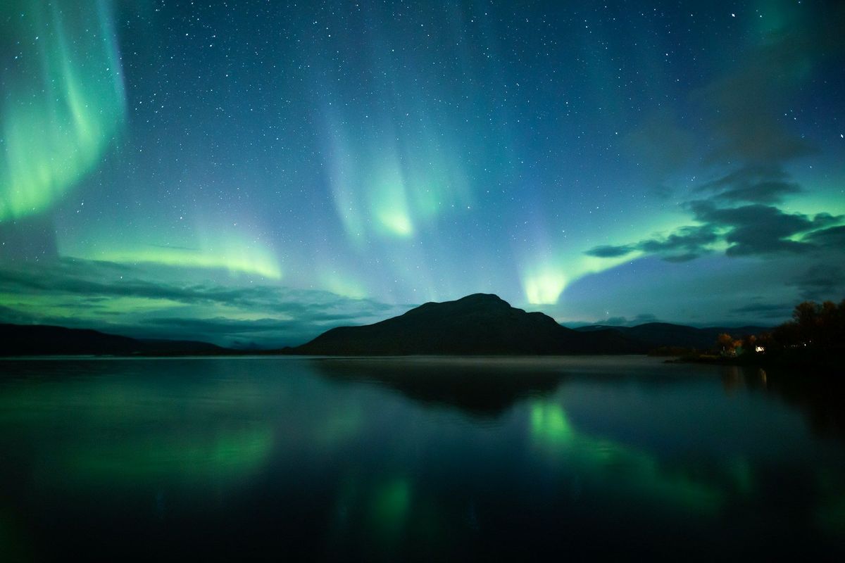 The northern lights reflected in a still lake