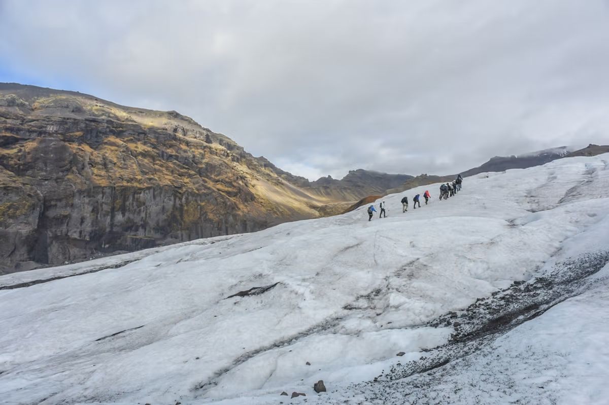 Landscape View Of Skaftafell Glacier With Private Guide and Group Of Hikers Walking On Glacier