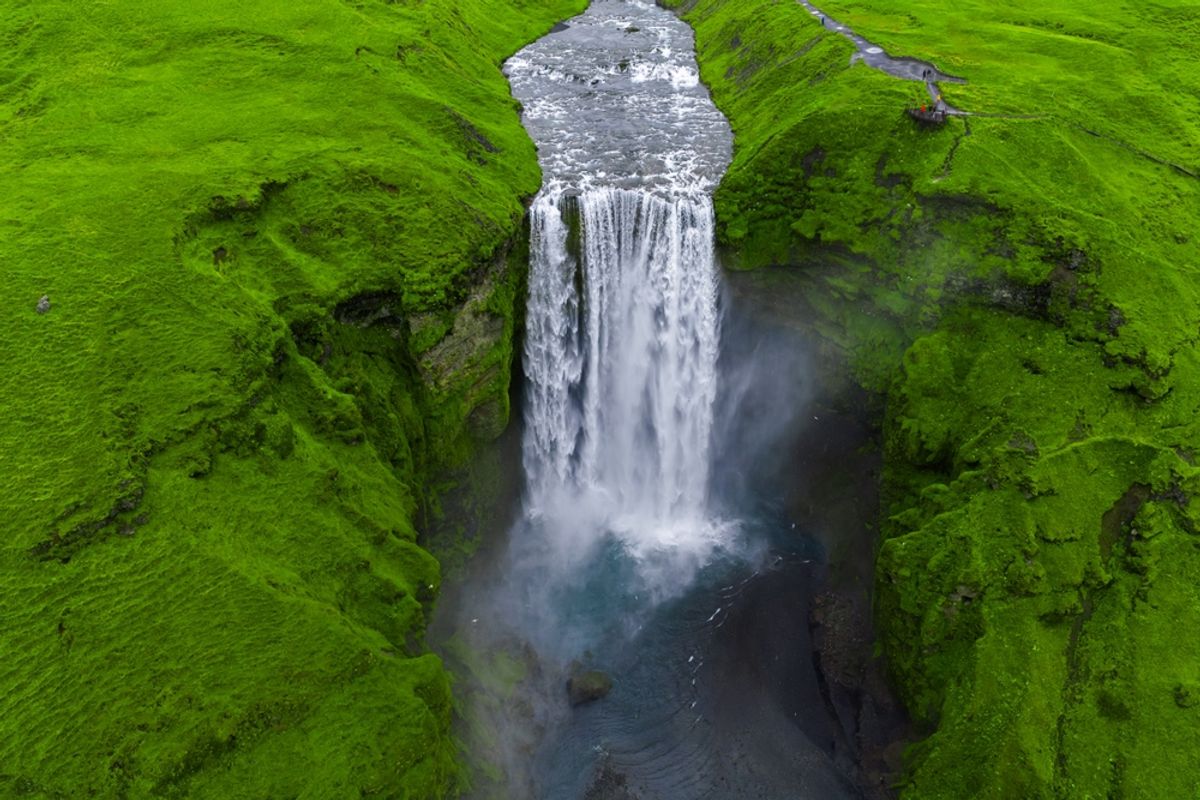 Aerial view of Skógafoss Waterfall plunging into a misty pool in southern Iceland