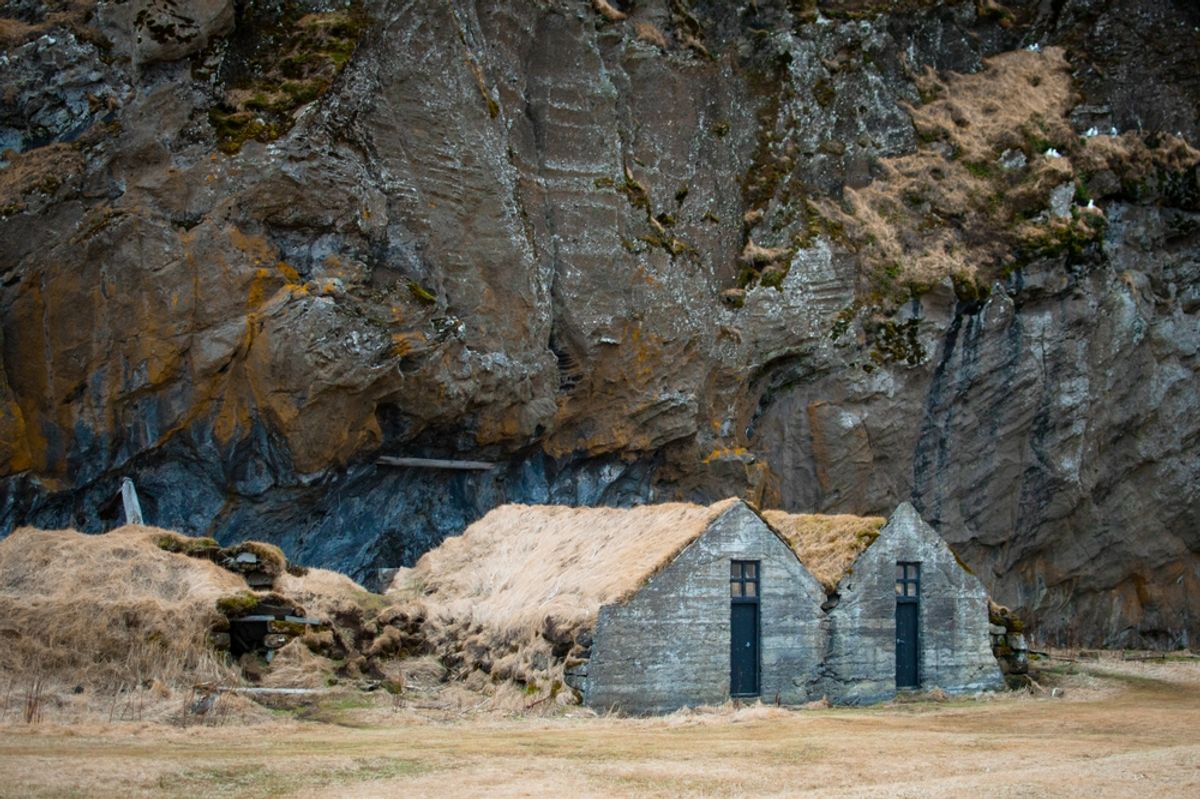 Turf house at foot of Drangurinn Rock in Southern Iceland