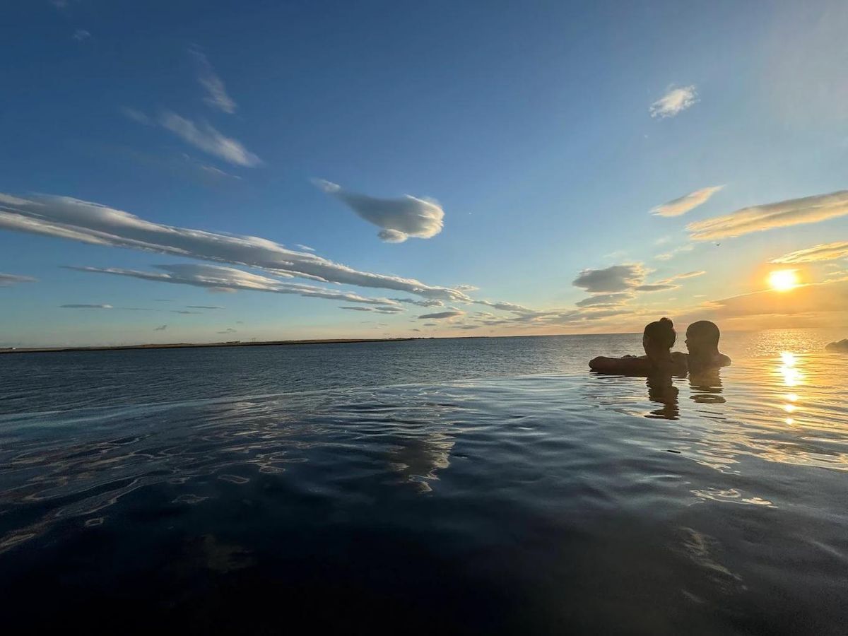 A couple watching the sunset from Sky Lagoon