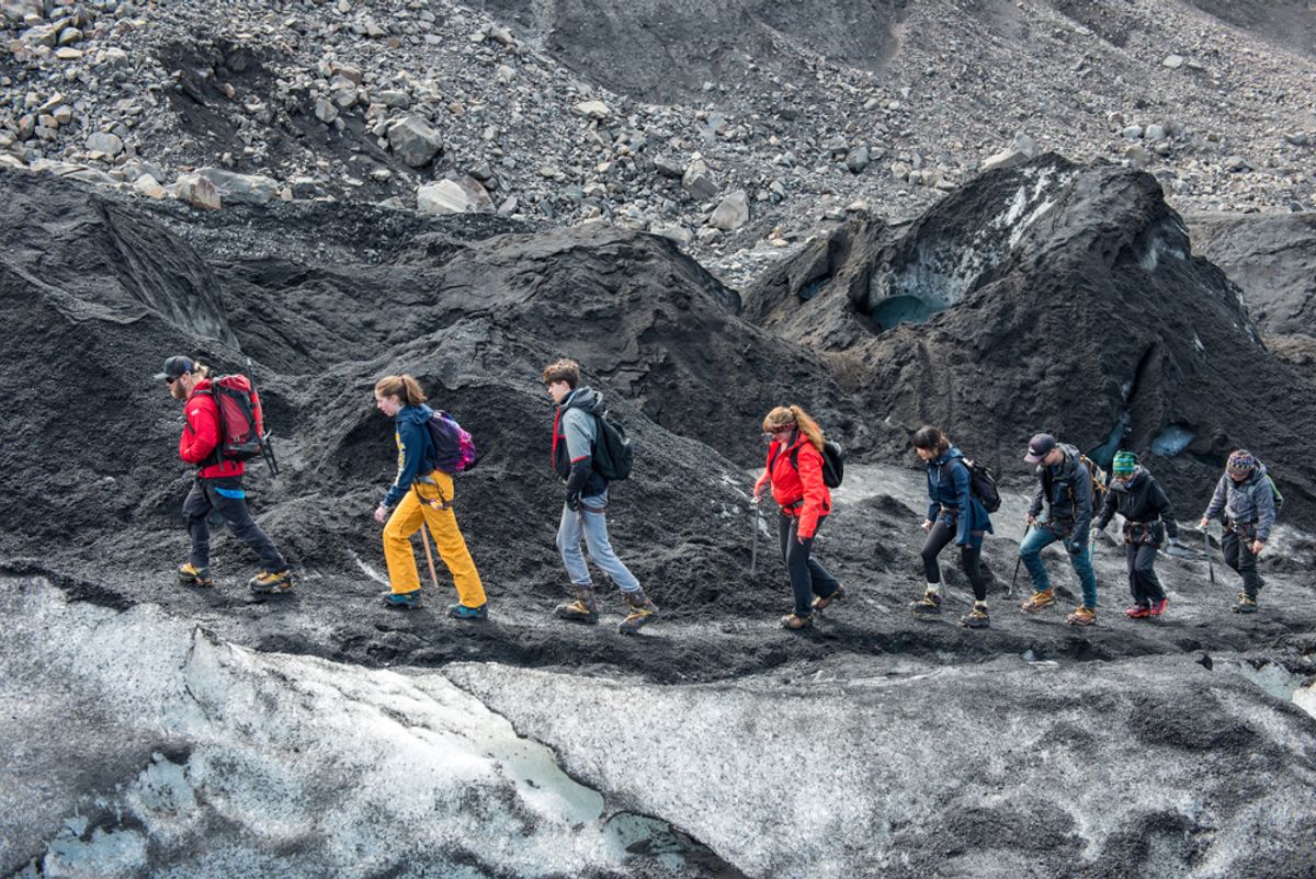 Tourists making a glacier hiking with a private tour guide in the Solheimajokull, Iceland