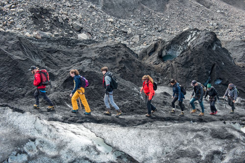 Tourists making a glacier hiking with a private tour guide in the Solheimajokull, Iceland