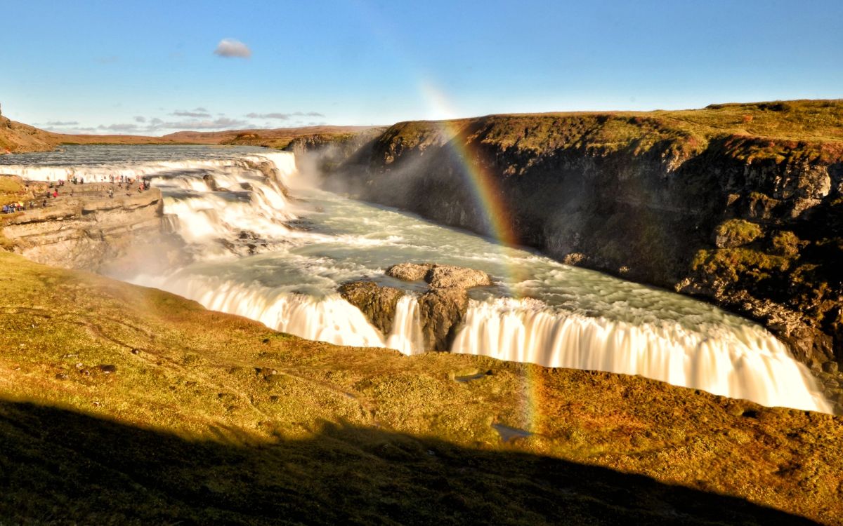 Gullfoss waterfall with a rainbow arcing through the spray above the canyon