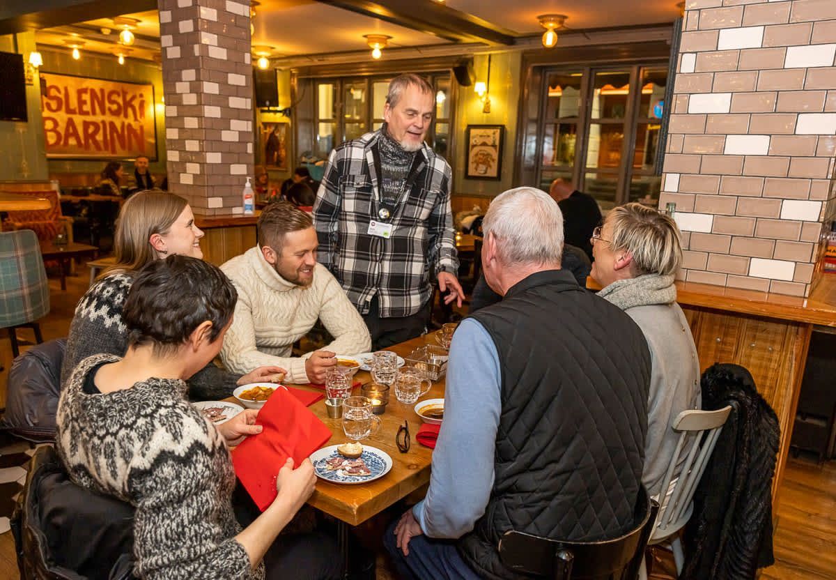 A guide with a group at a pub table
