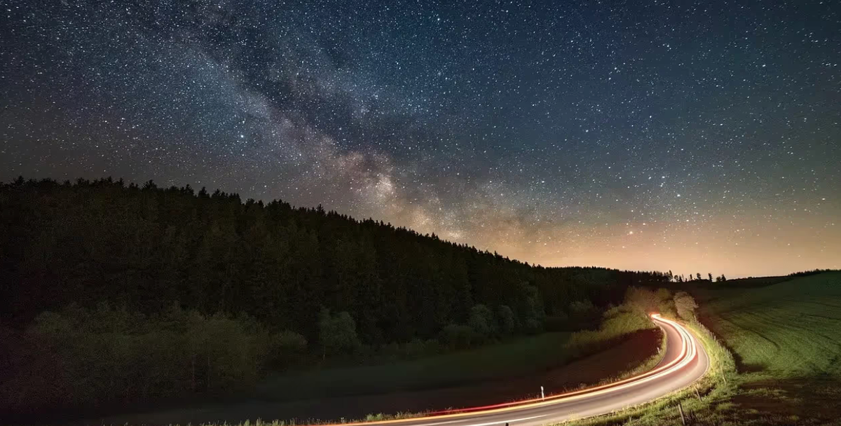 A night road under stars and the Milky Way