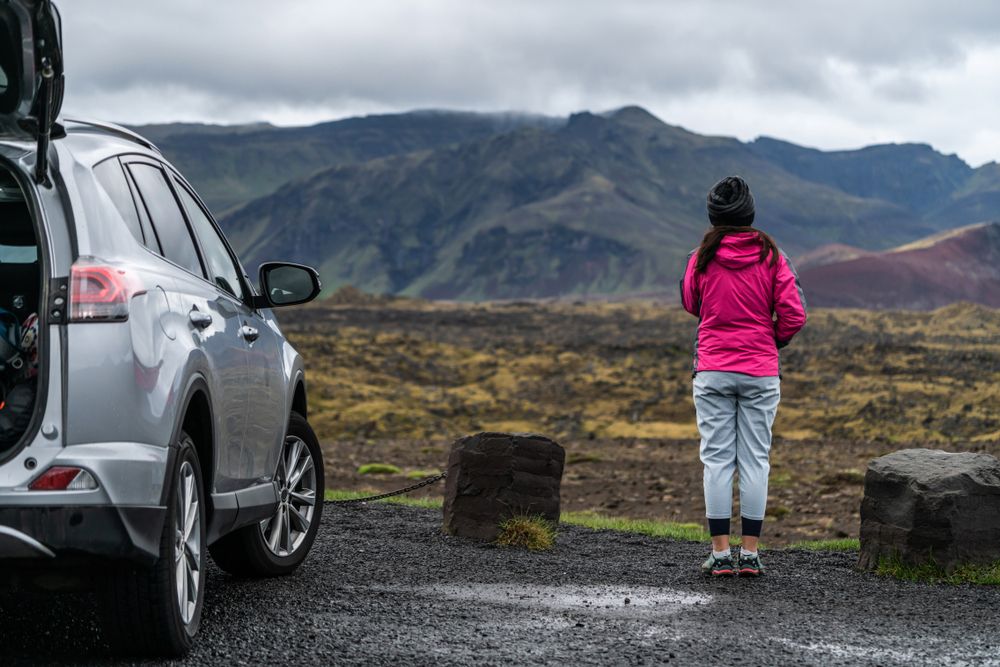 Woman tourist travel by SUV car for road trip in Iceland