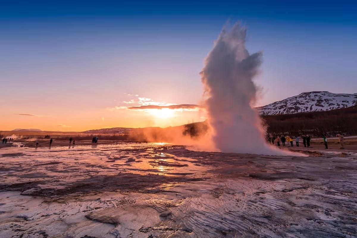 Strokkur erupting at Geysir in golden sunset light