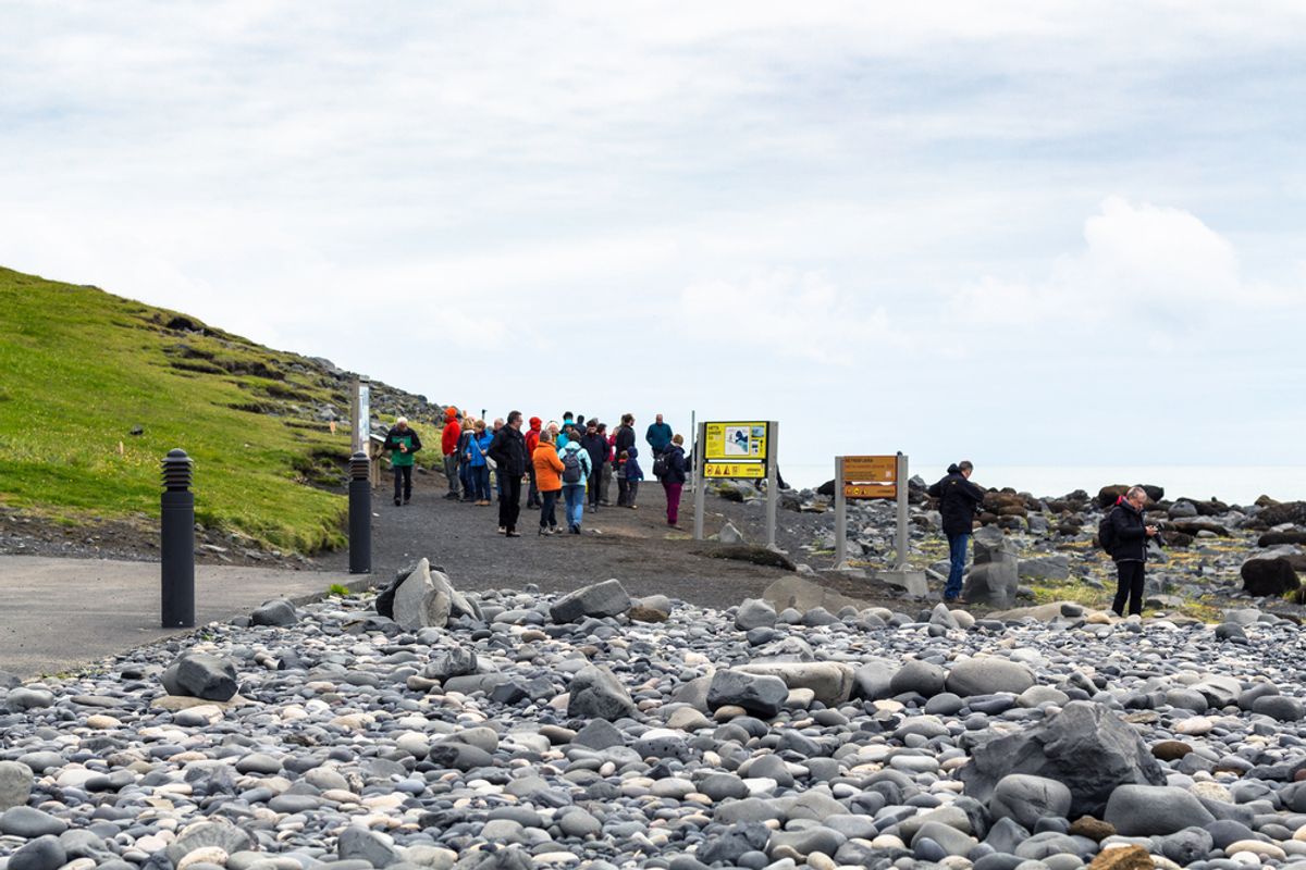 Tourists on Reynisfjara black sand beach near Vík í Mýrdal on Iceland’s South Coast in Katla Geopark in September