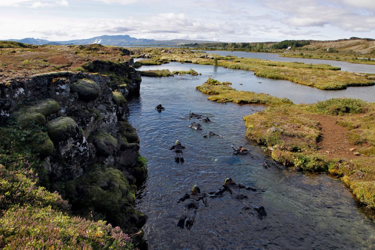 Snorkellers climbing out of the Silfra lagoon at the end of the route