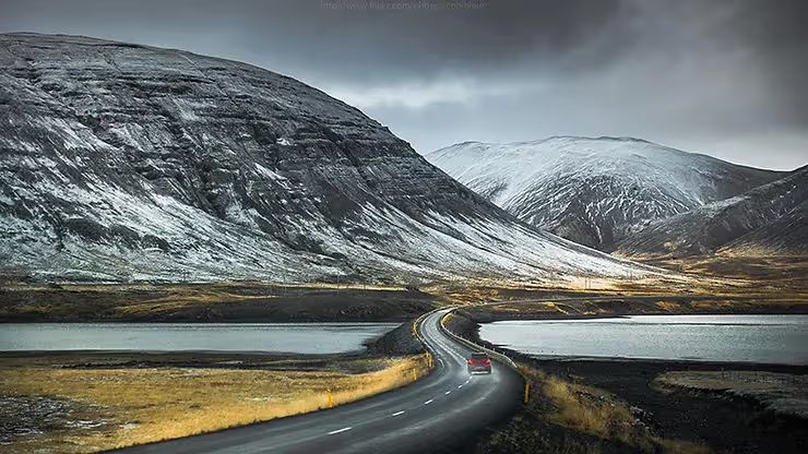 Rental 4WD car on a gravel road in the Icelandic countryside