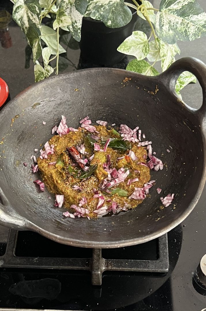 Chukka kura Pachadi served in a black mud pan.