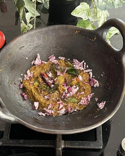 Chukka kura Pachadi served in a black mud pan.