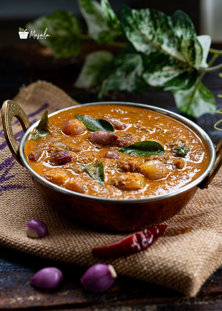 Small onion curry served in a copper kadai.