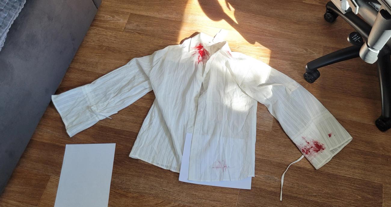 White shirt with a blood on it