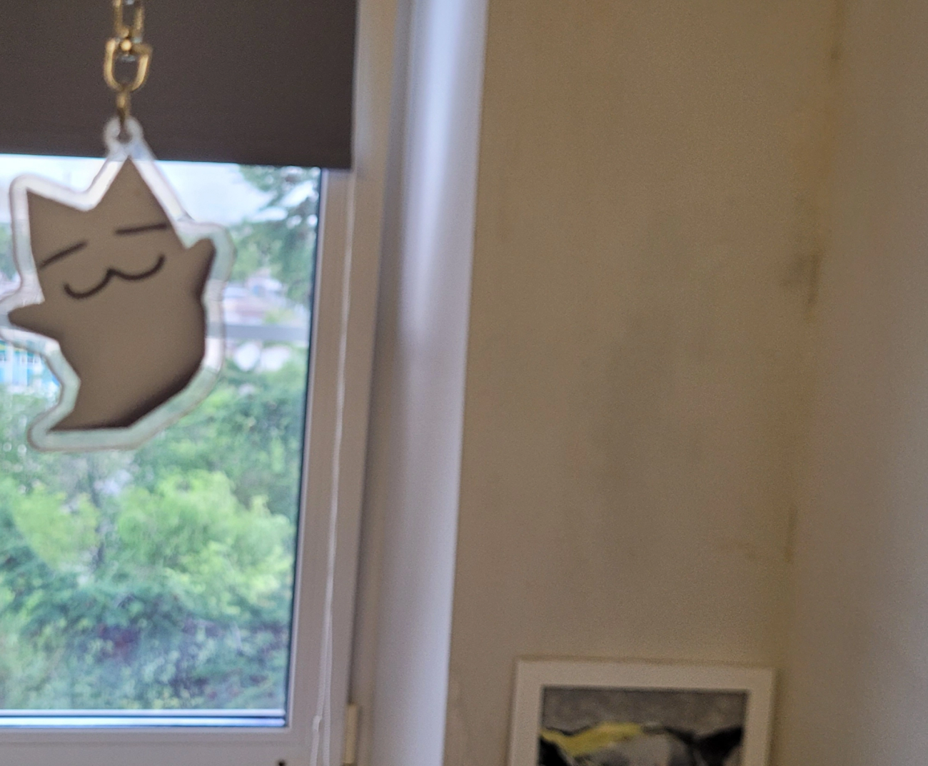 Funny ghost trinket with a dirty wall and a window on a background