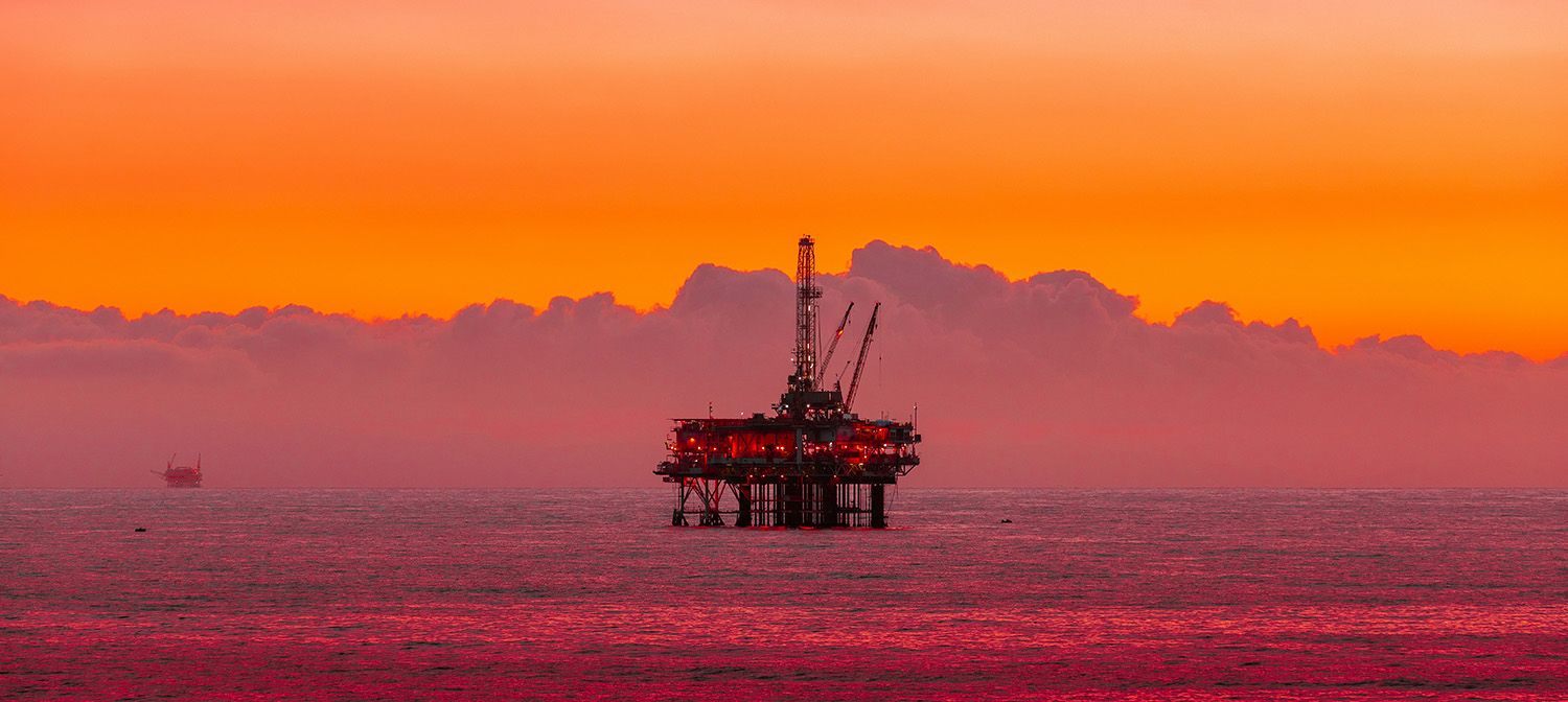 Offshore rig in the ocean at sunset