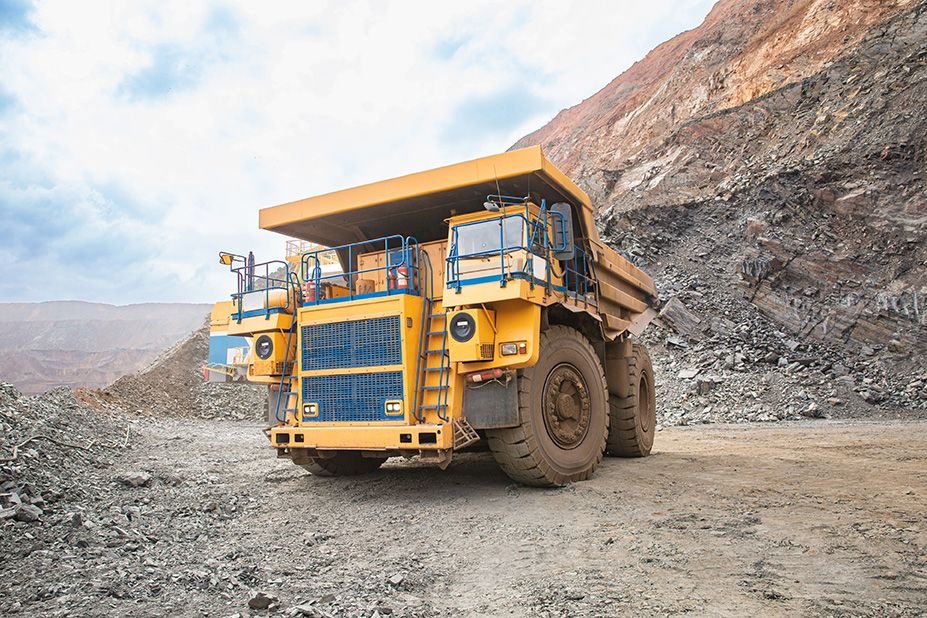 Big yellow dump truck on a mining site