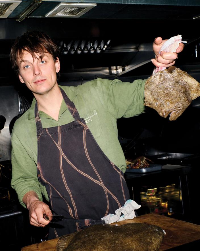 Tom Straker holding a turbot for camera