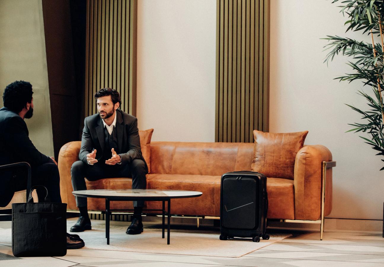 2 men talking in hotel lobby