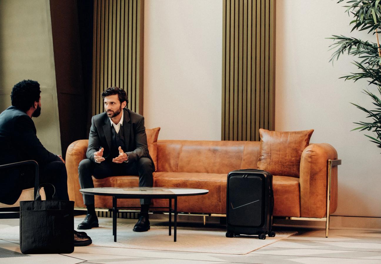2 men talking in hotel lobby