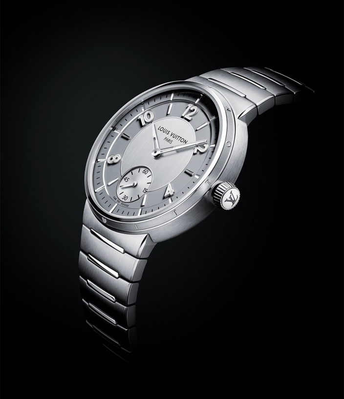 Crown and watch face of the Louis Vuitton Tambour Automatic 40mm Steel watch on a black back drop