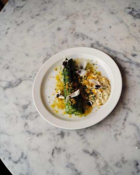 Plate of asparagus in dressed in sauce