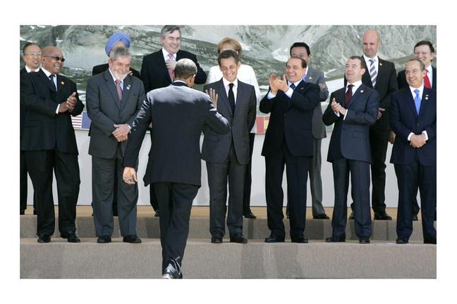 Leaders applaud as U.S. President Barack Obama, center, arrives for a group photo of G8 and G5 leaders at the G8 summit in L'Aquila, Italy on Thursday, July 9, 2009. Leaders from front row left to right, South Africa's President Jacob Zuma, Brazil's President Luiz Inacio Lula Da Silva, French President Nicolas Sarkozy, Italian Prime Minister Silvio Berlusconi, Russian President Dmitry Medvedev, Mexico's President Felipe Calderon. Back row left to right, China's State Councilor Dai Bingguo, India's Prime Minister Manmohan Singh, British Prime Minister Gordon Brown, German Chancellor Angela Merkel, Japanese Prime Minister Taro Aso, Sweden's Prime Minister Fredrik Reinfeldt and European Commission President Jose Manuel Barroso. (AP Photo/Michel Euler, Pool)