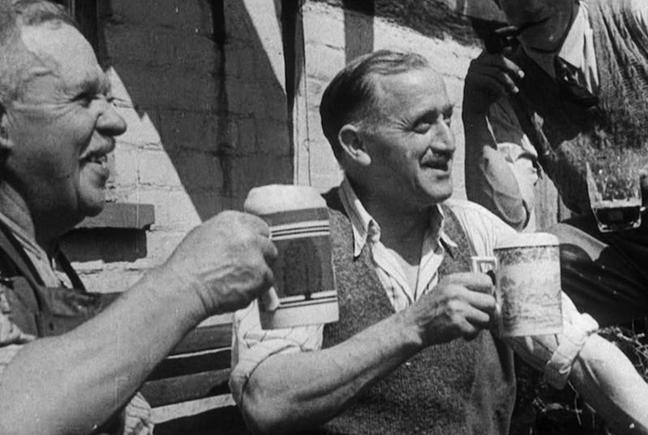 Two men drinking from china pint mugs, from the film Down at the Local, 1945