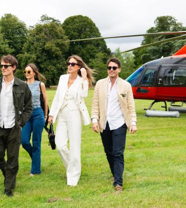Hugh Laughton-Scott, Tom Straker, Rachel Geraghty, Daisy Knatchbull and Gionzy Damiani walking away from the red helicopter