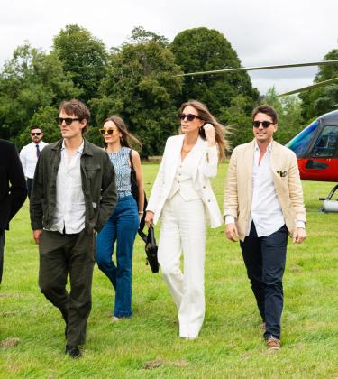 Hugh Laughton-Scott, Tom Straker, Rachel Geraghty, Daisy Knatchbull and Gionzy Damiani walking away from the red helicopter