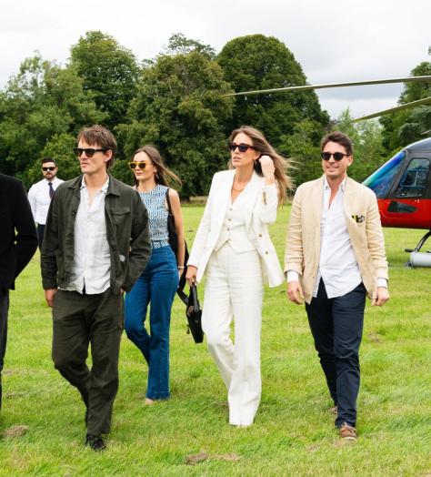 Hugh Laughton-Scott, Tom Straker, Rachel Geraghty, Daisy Knatchbull and Gionzy Damiani walking away from the red helicopter