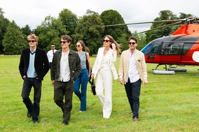 Hugh Laughton-Scott, Tom Straker, Rachel Geraghty, Daisy Knatchbull and Gionzy Damiani walking away from the red helicopter