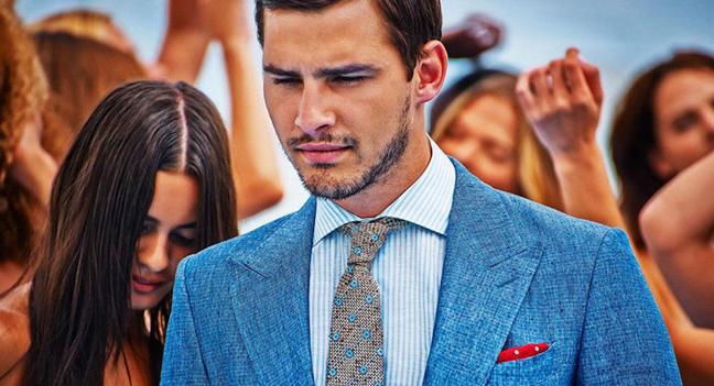 Suitsupply ad campaign with a model wearing a linen blue suit jacket