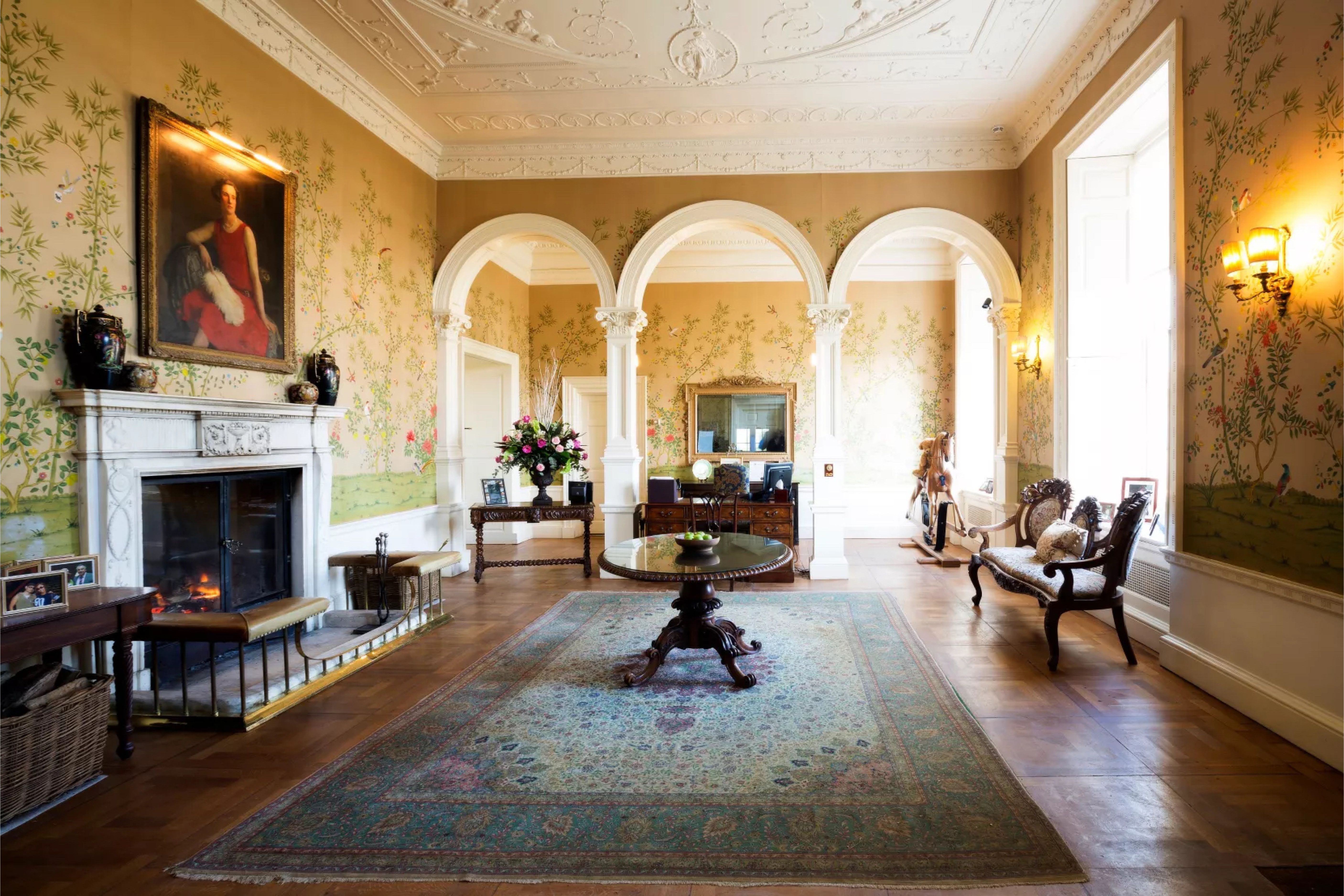 Reception rooms with ornate cornicing and arched openings at Stapleford Park