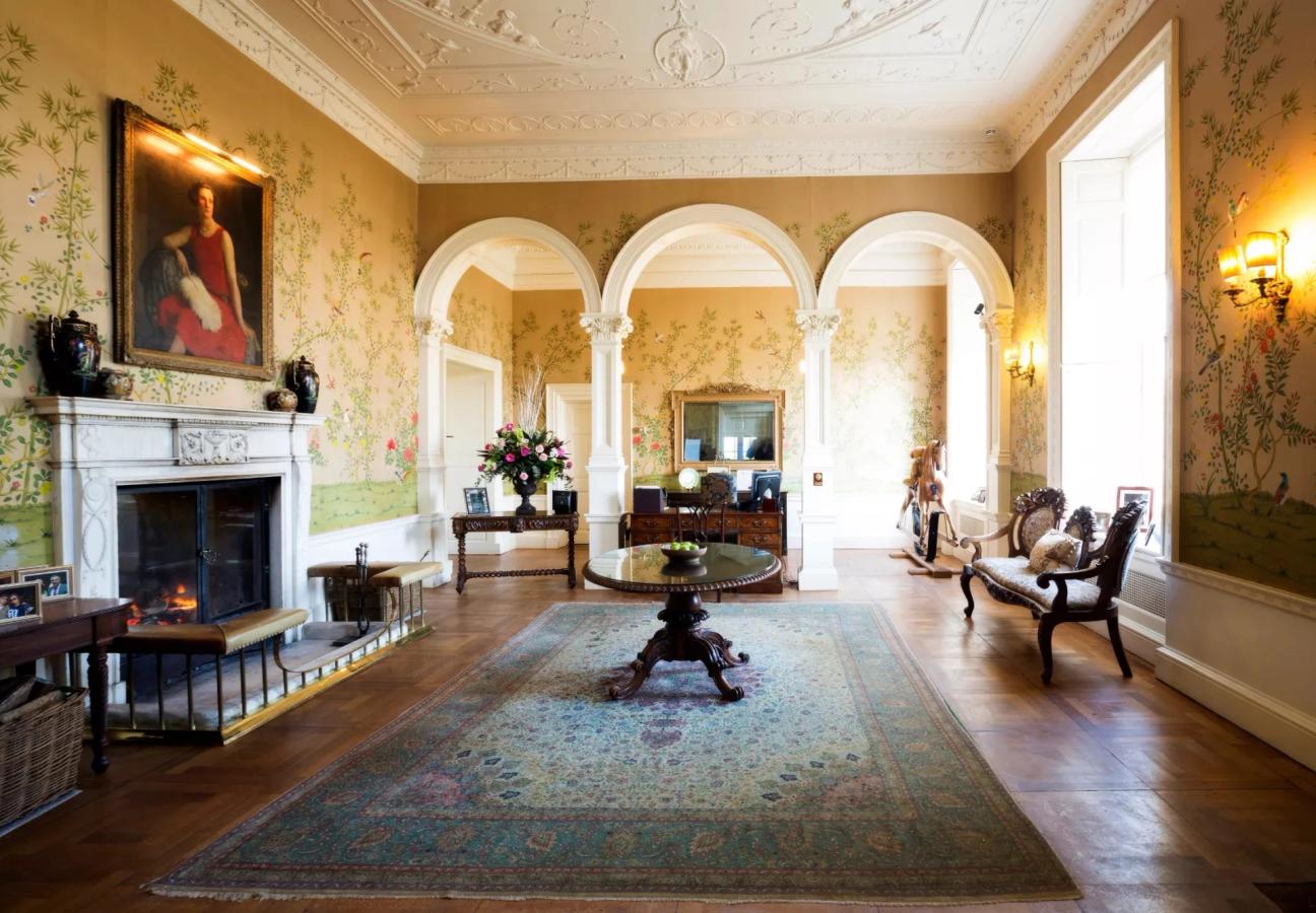 Reception rooms with ornate cornicing and arched openings at Stapleford Park